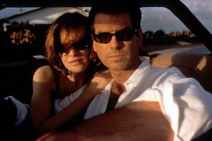 Pierce Brosnan and Rene Russo sitting in a car together in a scene from the film 'The Thomas Crown Affair', 1999. (Photo by Metro-Goldwyn-Mayer/Getty Images)